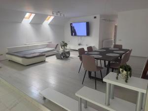 a living room with a table and a couch at AME Home Apartament 2 in Ocna-Mureşului