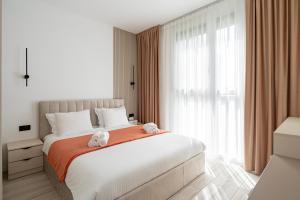 a bedroom with a large bed with two stuffed animals on it at A&R Residence Nest in Arad