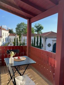 a table and chairs on a balcony with a view at Casa N'Aninhas - Santar in Santar