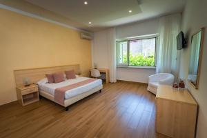 a hotel room with a bed and a window at Casa Vacanza San Pietro in Maiori +144 photos