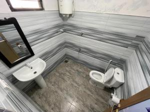 a bathroom with a sink and a toilet at ocean breeze in Challi