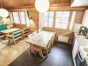 a dining room with a wooden table and chairs at Holiday Home Naavarinne by Interhome in Muonio