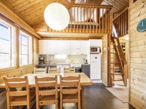 a kitchen and dining room with a table and chairs at Holiday Home Naavarinne by Interhome in Muonio +15 photos