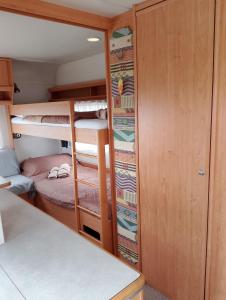 a small room with bunk beds in a boat at Terra Oliva in Vátos