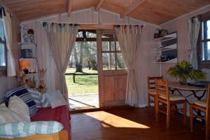 a room with a couch and a table and a door at Gite foret landaise in Sainte-Eulalie-en-Born