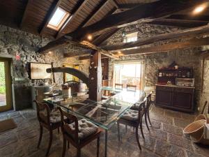 a dining room with a glass table and chairs at Quinta das Buganvílias in Castelo Branco