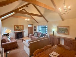 a living room with a couch and a fireplace at Meadow Cottage in Fowey