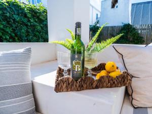a bottle of wine and lemons sitting on a couch at Rose Pearl in Paternoster +5 photos