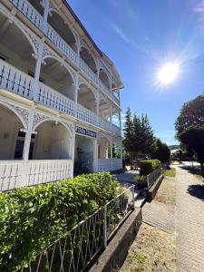 a white building with a fence in front of it at Villa Victoria in Binz +15 photos