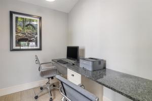 a room with a desk with a computer and a chair at Best Western Acadia Park Inn in Bar Harbor +30 photos
