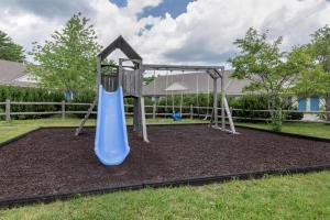 a playground with a blue slide in a yard at Best Western Acadia Park Inn in Bar Harbor