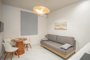 a living room with a couch and a table at Agora Luxury Suites in Lixouri