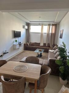 a living room with a couch and a table at Nadrs in Tangier