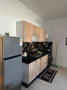 a kitchen with a refrigerator and a stove at Nadrs in Tangier