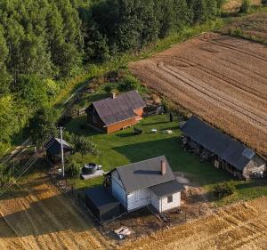 an aerial view of a farm with a barn at Magia Leśnych Dolin Zwiartów 44, 22-610 Krynice in Zwiartów