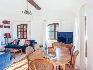 a living room with a table and a couch at Villa Balcon d'Azur by Interhome in Spéracèdes