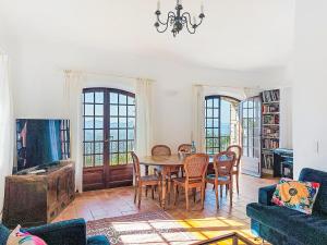 a living room with a table and chairs at Villa Balcon d'Azur by Interhome in Spéracèdes