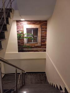 a staircase in a building with a window and a plant at Asghar Ali Resort in Lower Topa +1 photo