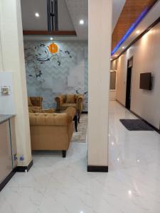 a living room with couches and a wall at Asghar Ali Resort in Lower Topa