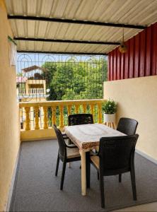 a table and chairs on a balcony with a view at Serenity Casa II in Varca