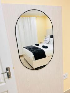 a mirror reflection of a bed in a bedroom at MrP Guest House in Kokstad +5 photos
