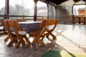 a table and two chairs on a patio at Wellez Vendégház in Sajóvelezd