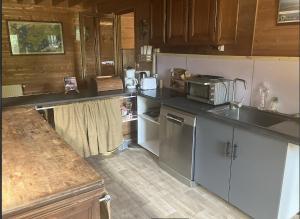 a kitchen with a sink and a counter top at La petite maison sur la colline in Rue