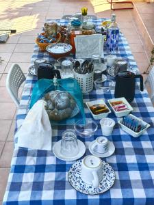 a blue and white table with food and dishes on it at B&B L'Assiolo in Ancona