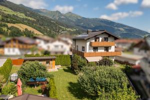 a model of a house with mountains in the background at Alpenplatzl XS in Bad Hofgastein