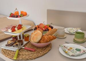 a table topped with a tray of bread and fruit at Alpenplatzl XS in Bad Hofgastein