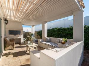 a patio with a couch and a table at Rose Pearl in Paternoster