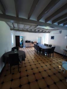 a dining room with tables and chairs in a building at Domaine Sylvaria in Lassay-sur-Croisne +11 photos