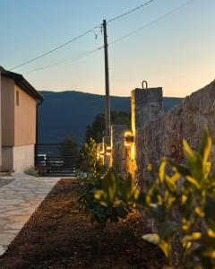 a stone wall with a view of the mountains at Apartman Đurišić in Prijevor