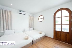 a white room with a couch and a window at Amornrut Hill 03 in Ban Tao Than
