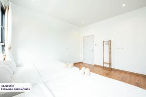a white bedroom with a large bed with white sheets at Amornrut Hill 03 in Ban Tao Than +47 photos