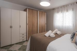 a bedroom with a bed with two pillows on it at Casa del sol Armilla in Armilla +76 photos