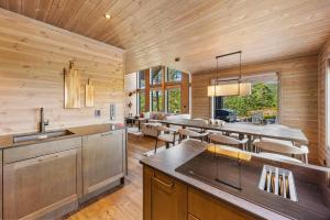 a kitchen with wooden walls and a dining room at Reno Hytta in Eggedal