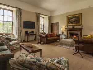a living room filled with furniture and a fireplace at Apartment Macduff Tower by Interhome in Angus
