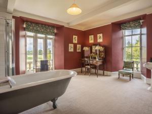 a bath tub in a bathroom with red walls at Apartment Macduff Tower by Interhome in Angus