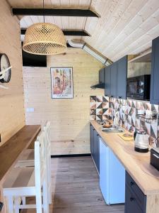 a kitchen with blue cabinets and a wooden counter at Domek Słoneczna in Mieroszyno