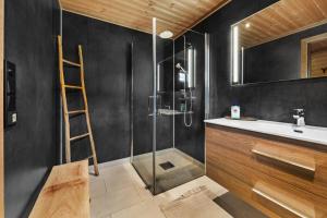 a bathroom with a shower and a sink and a ladder at Reno Hytta in Eggedal