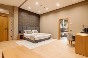 a bedroom with a bed and a desk in a room at Diplomatico Hotel in Odesa