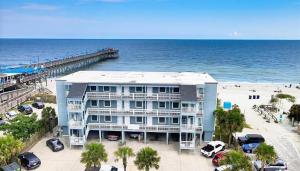 a large building on the beach next to the ocean at Exceptional Ocean-Pier-Pool Front 1 BR Condo in Myrtle Beach