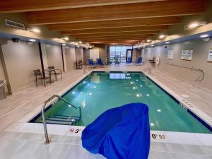 a large indoor swimming pool in a building at Home2 Suites By Hilton Bloomington Normal in Normal