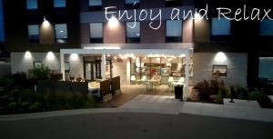 a view of a house at night with a kitchen at Home2 Suites By Hilton Bloomington Normal in Normal