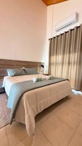 a bedroom with a bed with two towels on it at Apart Ogaraity Hotel in Goya