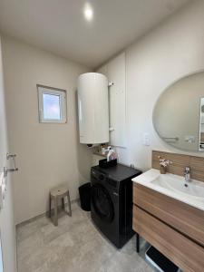 a bathroom with a washing machine and a sink at Les Iles d'ici in Rochefort +47 photos