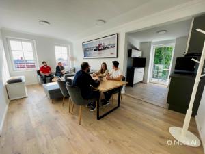 a group of people sitting at a table in a room at Fewo-meerblick-Rügen in Altefähr