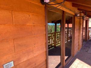 an outside view of a wooden house with an open door at Embellupe Breakfast included in San Jose del Pacifico