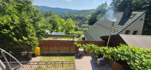 an aerial view of a house with a fence and vines at Leśna Przygoda ,,Balia w cenie" in Harbutowice +5 photos